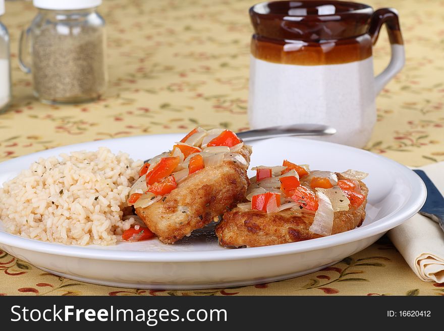 Fried pork cutlets with peppers and onions with rice. Fried pork cutlets with peppers and onions with rice