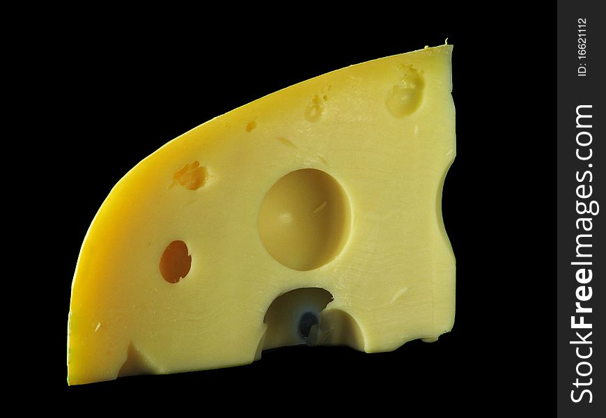 A peace of swiss cheese on black