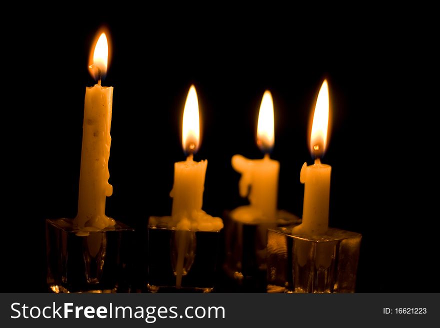 Two Christmas Candles. Red candles with bright glowing flames on a black background. Two Christmas Candles. Red candles with bright glowing flames on a black background.