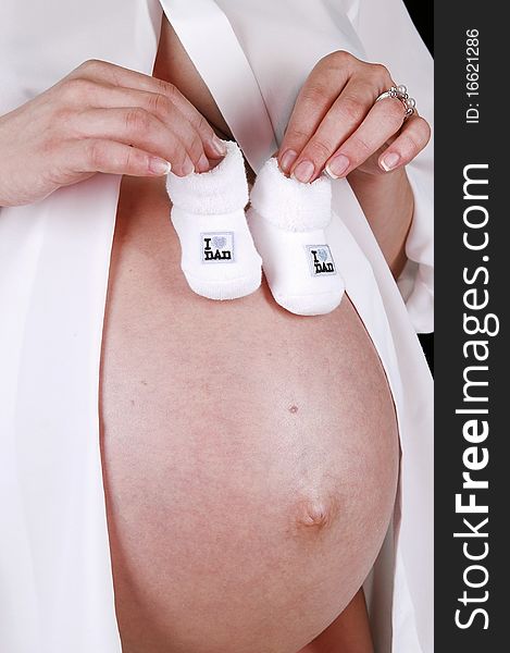 Pregnant belly in the studio on a white background