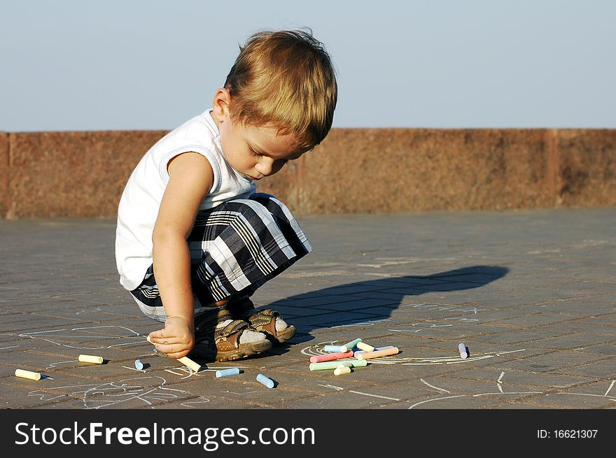 Child Draws With Crayons