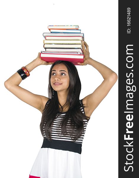 Young teenage girl holding books. Isolated on a white background.