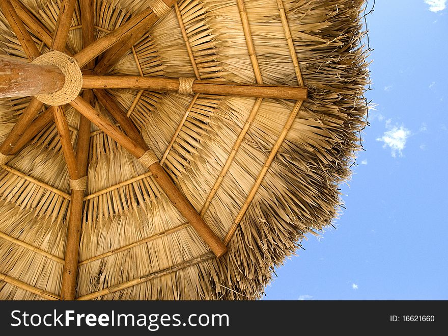 View of a thatched umbrella from underneath.