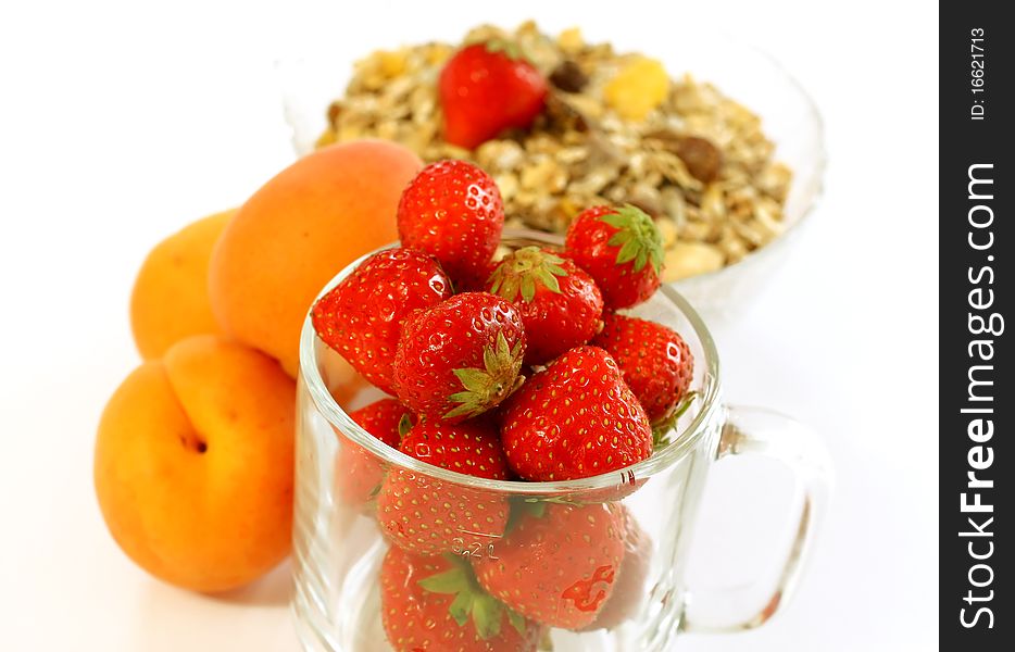 Strawberry in glass and muesli isolated on white