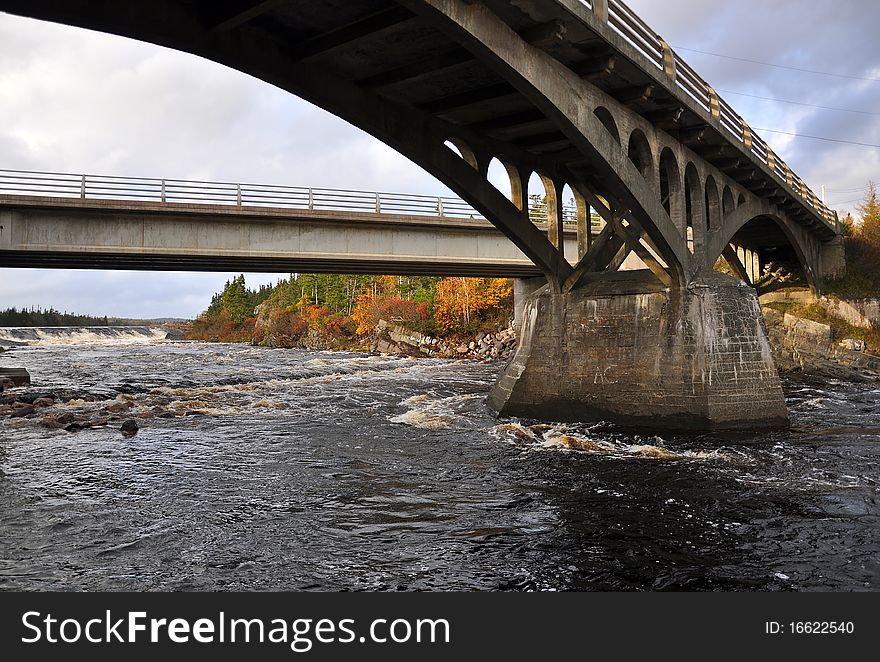 Dramatic wide angel view of bridges spanning a set of rapids in back country of Newfoundland. Dramatic wide angel view of bridges spanning a set of rapids in back country of Newfoundland.