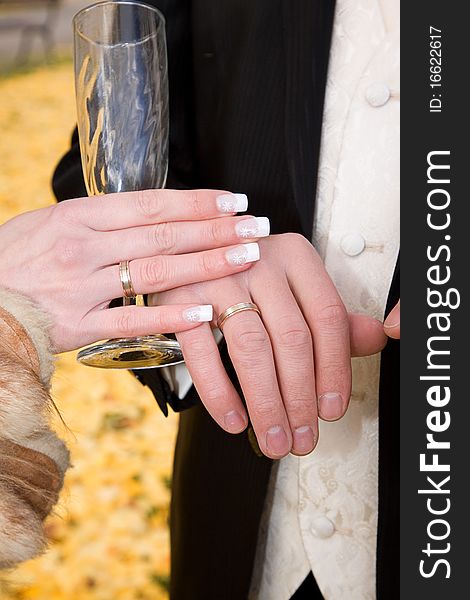 Hands of bride and groom with empty champagne glass. Hands of bride and groom with empty champagne glass