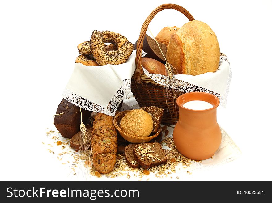 Still-life with  different bread products and jug of milk on white background. Still-life with  different bread products and jug of milk on white background.