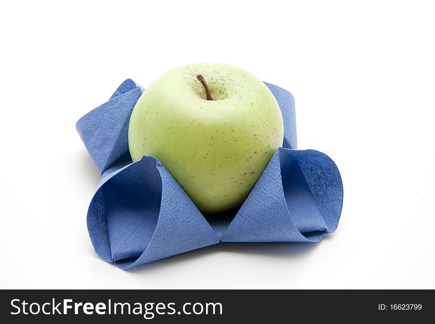 Apple in bluer folded napkin. Apple in bluer folded napkin