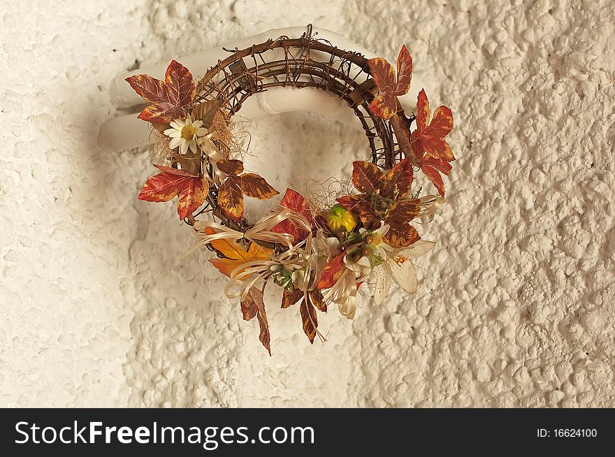 An autumn wreath on a white wall