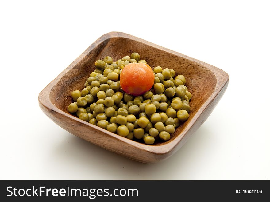 Wood bowl with peas and carrot