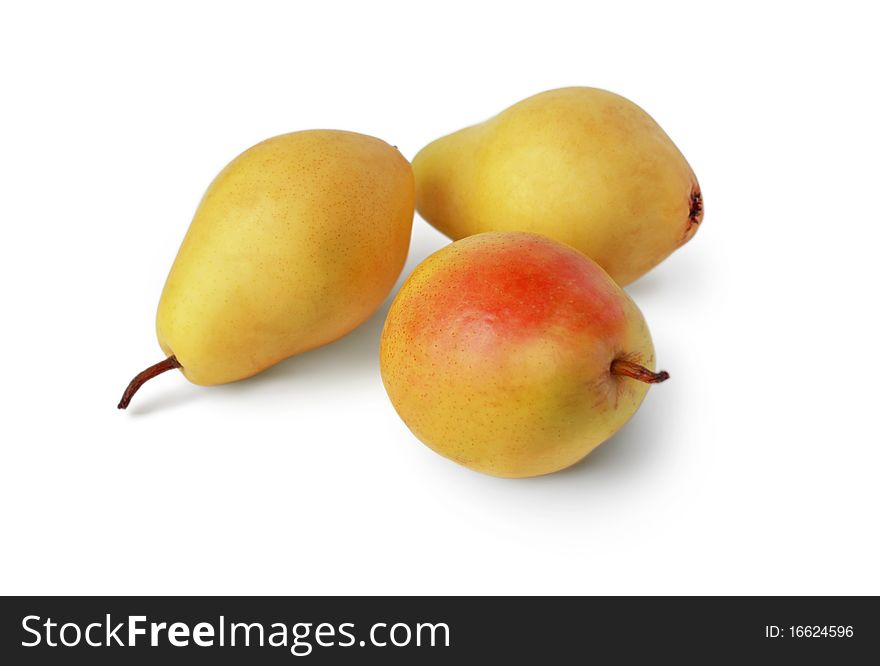 Three ripe yellow pears on a white background