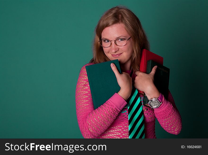 Cute young girl with books in studio