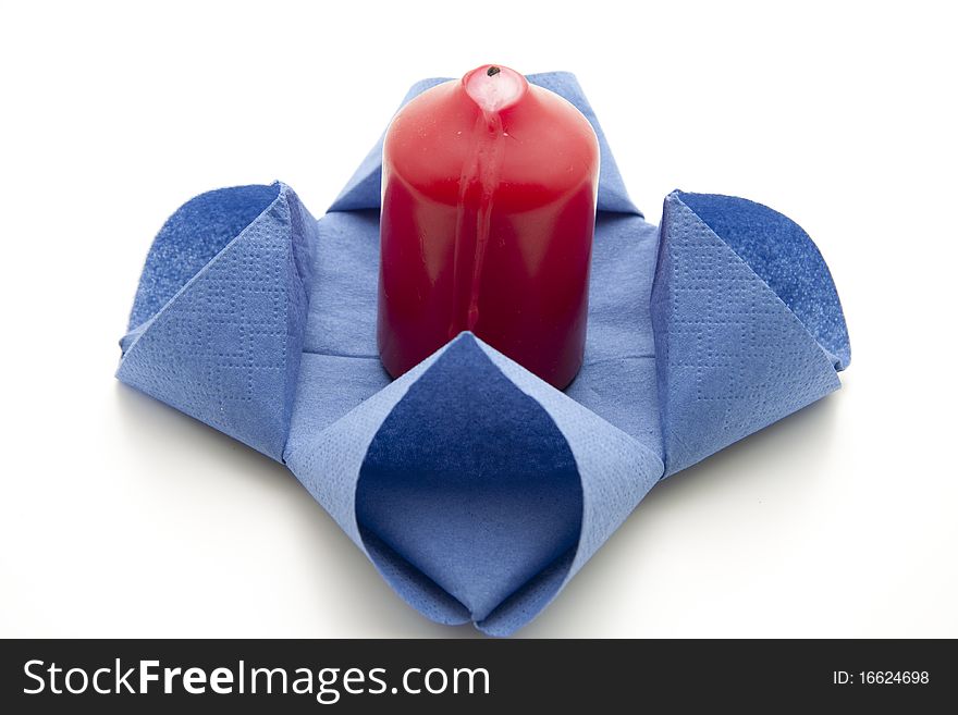 Blue folded napkin with red candle