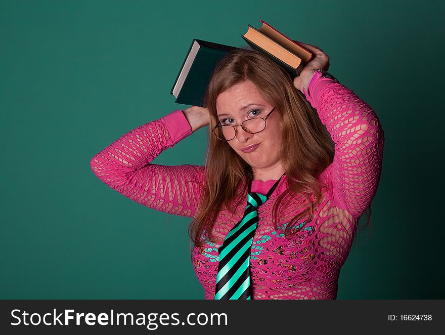 Cute young girl with books in studio