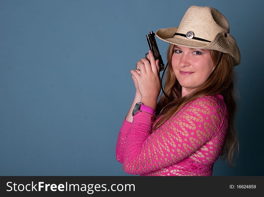 Cute young girl with gun in studio
