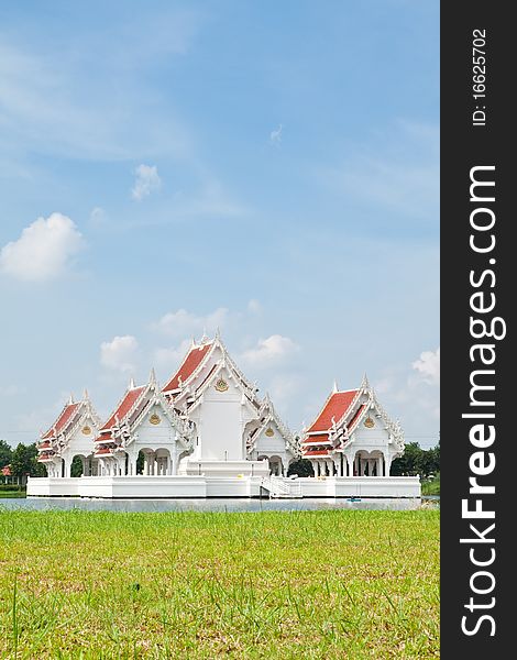 Blue sky and Thai style castle in the middle of pond