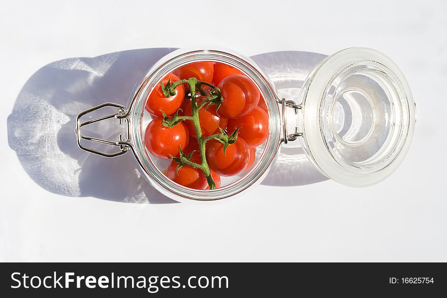 Food series: red ripe cherry tomato in jar