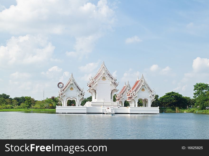 Blue sky and Thai style castle in the middle of pond