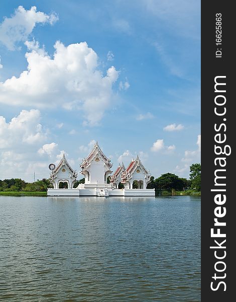 Blue sky and Thai style castle in the middle of pond