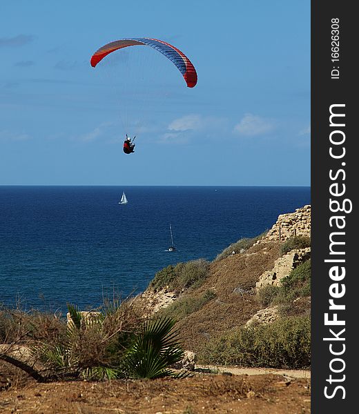 Paraglider over the sea.Small boats on the sea. Paraglider over the sea.Small boats on the sea