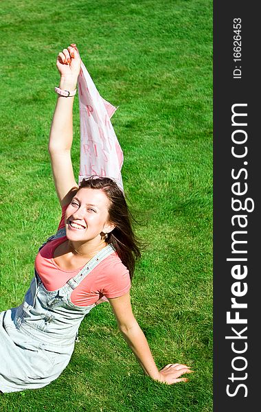 Positive girl relaxing on green grass. Positive girl relaxing on green grass