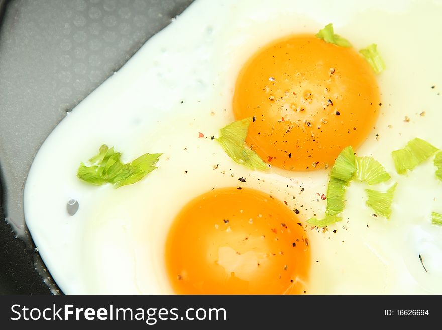 Image of two fried eggs in pan