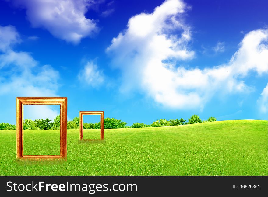 Blank Picture Frame Against Blue Sky And Green Grass