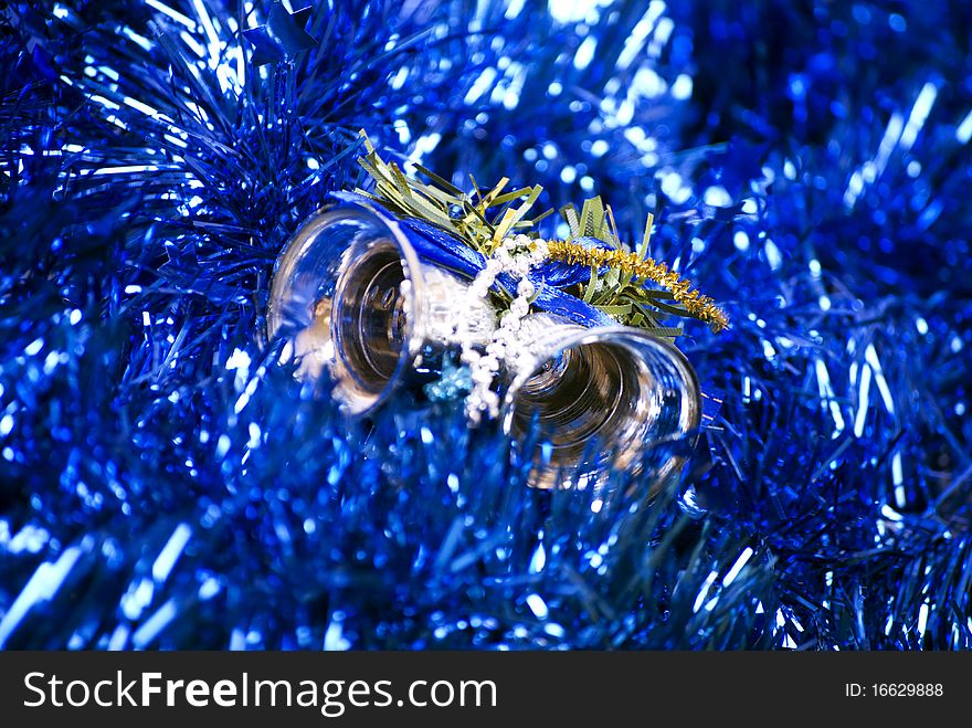 Blue glittering Christmas tinsel and silver bells. Blue glittering Christmas tinsel and silver bells