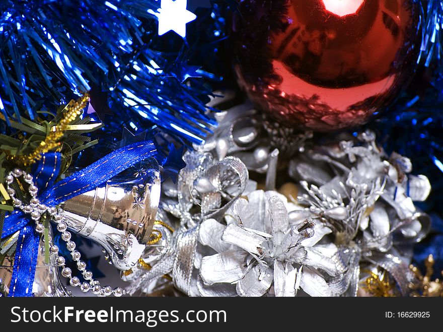 Red  Christmas ball, blue tinsel, silver bells  and decorative cone. Red  Christmas ball, blue tinsel, silver bells  and decorative cone