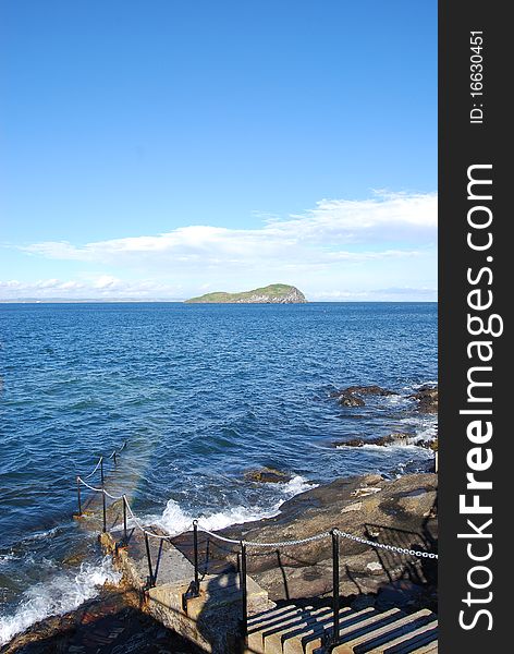 Stone steps descend into the stormy waters of the firth of Forth at North Berwick. Stone steps descend into the stormy waters of the firth of Forth at North Berwick