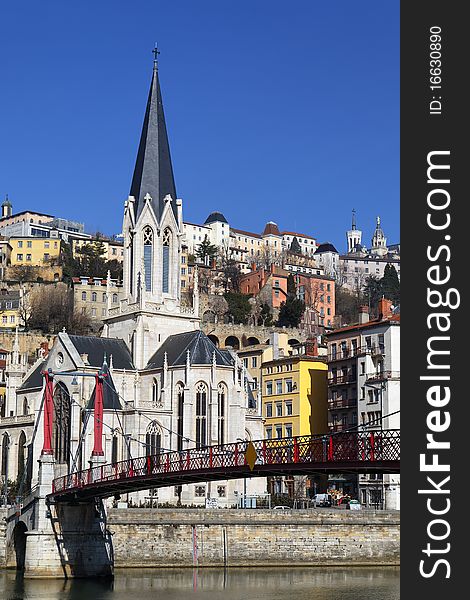 Red footbridge and church in Lyon (France)