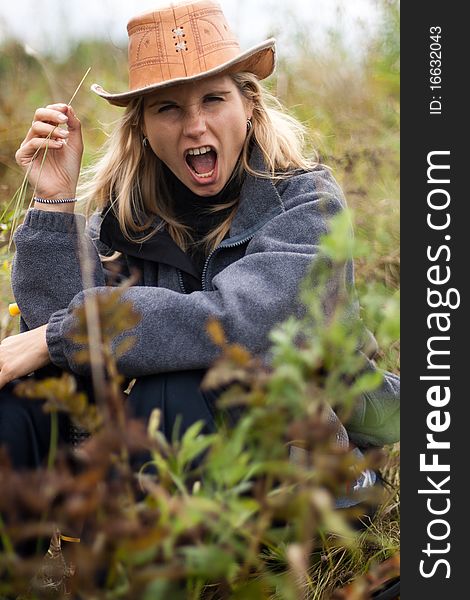 Girl in brown hat in field