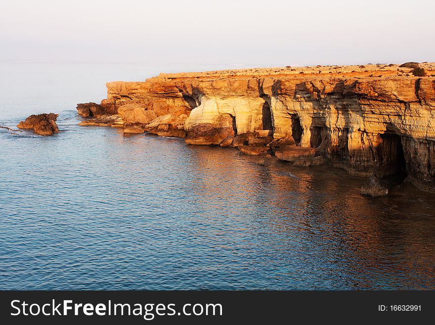 Sea caves near Cape Greko at dawn. Cyprus. Mediterranean Sea.