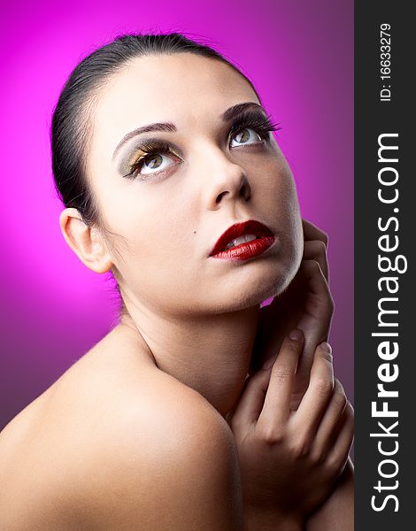 Beautiful woman over color background with beautiful makeup