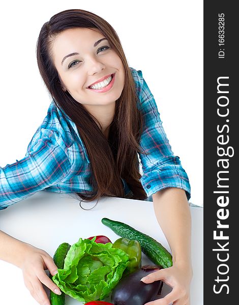 Young girl with vegetables over white background. Young girl with vegetables over white background