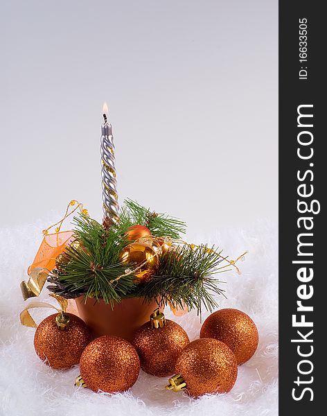 Christmas orange spheres and the silver candles on the white fur