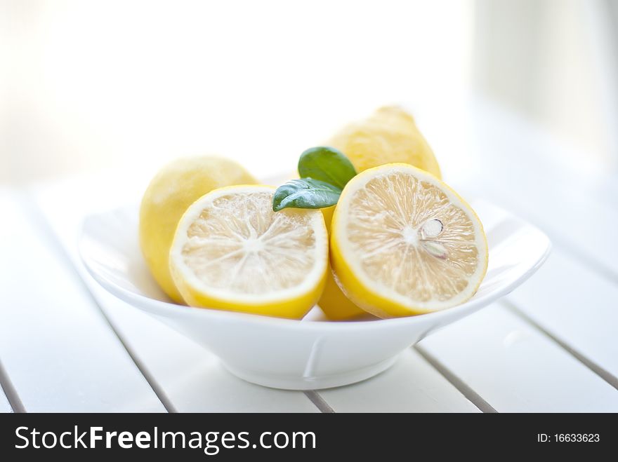 Beautiful fresh cut lemons on garden table. Beautiful fresh cut lemons on garden table