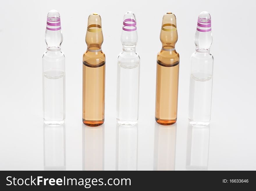 Medical ampules or vials in a row isolated on a white background