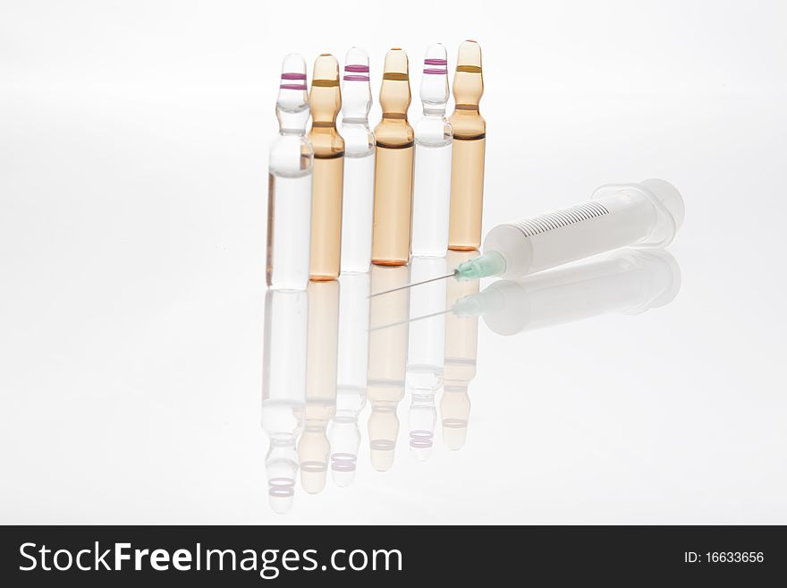 Medical vials or ampules with syringe isolated on white background. Medical vials or ampules with syringe isolated on white background