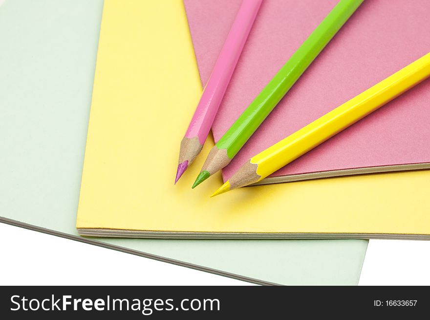 Copy-books and pencils on the background