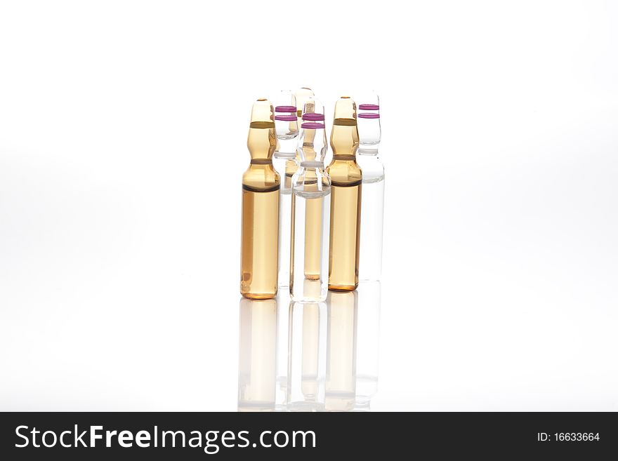 Medical ampules or vials in a row isolated on a white background. Medical ampules or vials in a row isolated on a white background