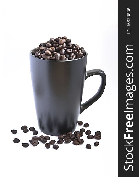 Black cup with coffee beans isolated on white background