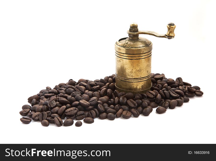 Vintage coffee grinder with coffee beans isolated on white