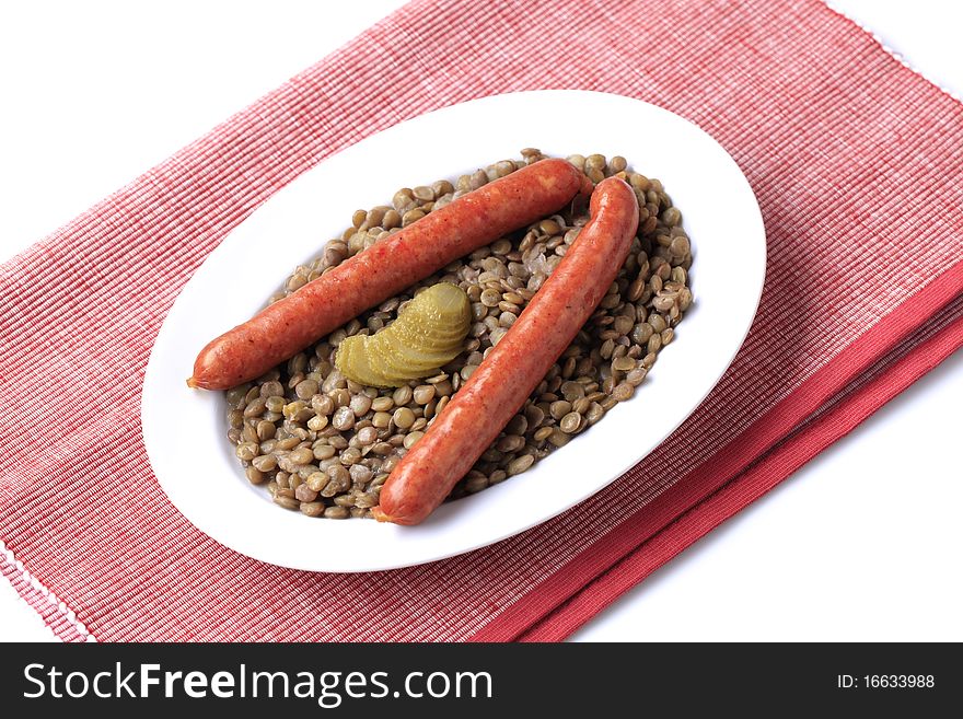 Lentils with spicy sausages and pickles - studio. Lentils with spicy sausages and pickles - studio