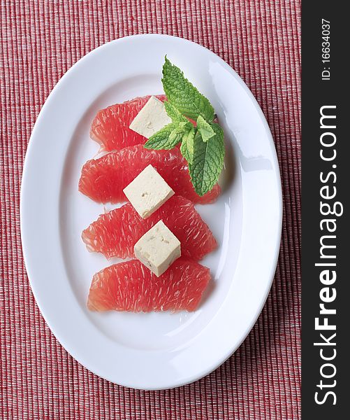 Pieces of red grapefruit and tofu - overhead