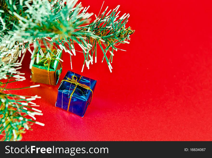 Christmas tree is richly decorated with a red background
