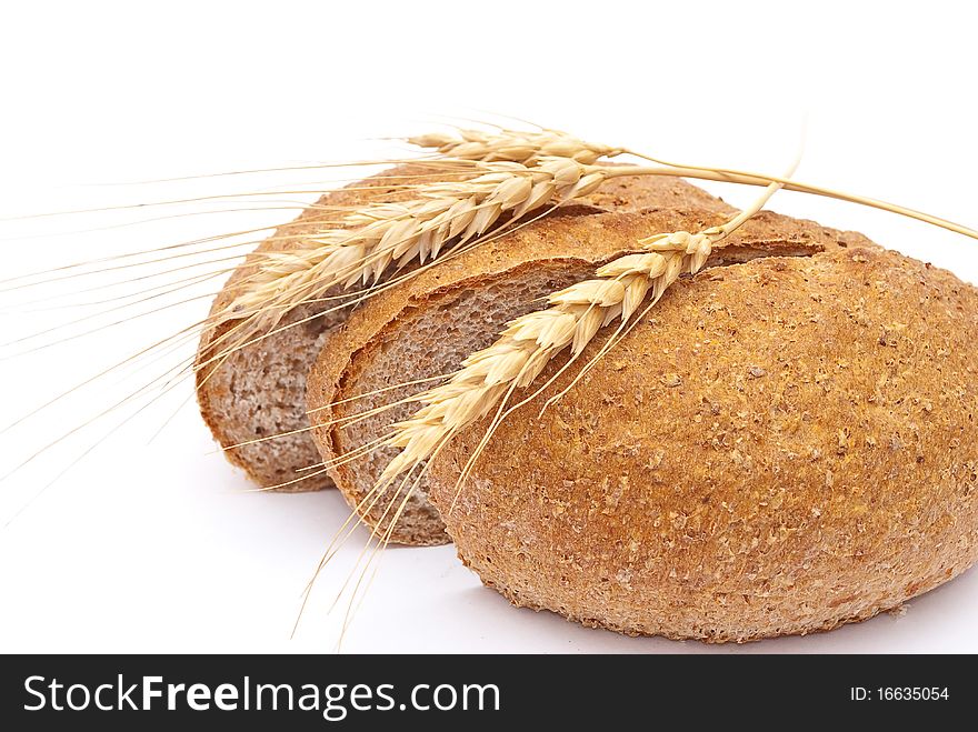 Bread with wheat and ears on white
