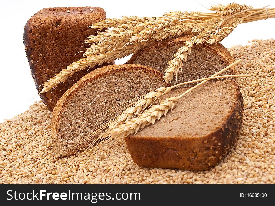 Bread with wheat and ears on white