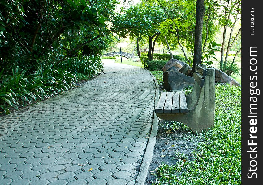 Bench and walkway at a public park in the afternoon Bangkok. Bench and walkway at a public park in the afternoon Bangkok