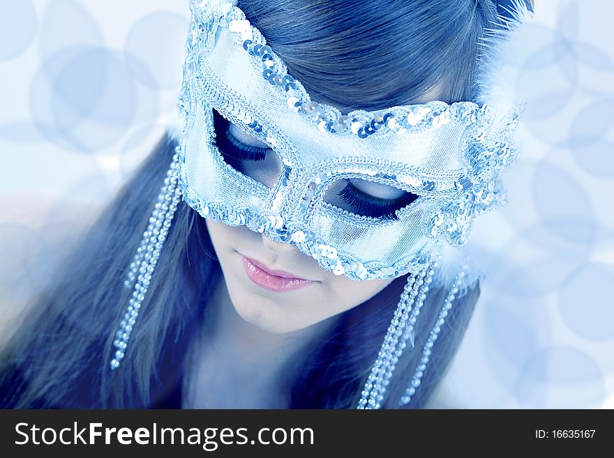 Wearing a glamour white party mask with closed eyes. Wearing a glamour white party mask with closed eyes